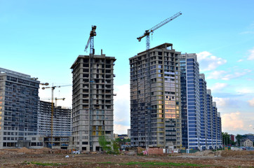 Fototapeta na wymiar Tower cranes at construction site, construction of high-rise building - Image