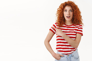 Fantastic deal check out. Amused good-looking redhead curly stylish girl wearing striped t-shirt...