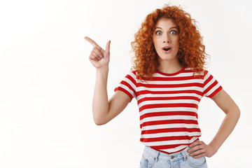 No way wow have you heard. Impressed fascinated good-looking redhead stylish girl drop jaw gasping amused smiling delighted wide eyes thrilled pointing upper left corner astonished, white background
