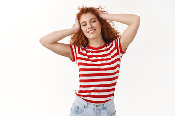 Beautiful tender european carefree redhead curly woman close eyes smiling happily feel relaxation...