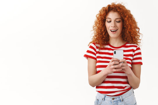 Redhead Girl Taking Picture Friend Secretly Recording Video Smartphone Look Playful Having Fun Smiling Broadly Peek Telephone Display Taking Cool Shot Standing White Background