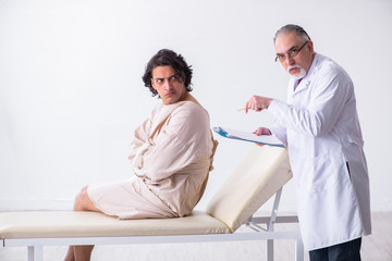 Aged male doctor psychiatrist examining young patient 