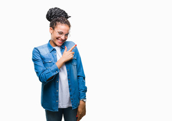 Young braided hair african american girl wearing glasses over isolated background cheerful with a smile of face pointing with hand and finger up to the side with happy and natural expression on face 