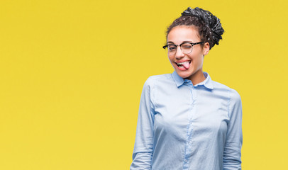 Young braided hair african american business girl wearing glasses over isolated background winking...