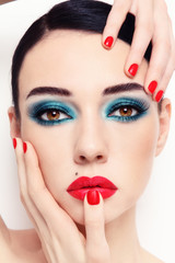 Close-up portrait of young beautiful woman with fancy green makeup