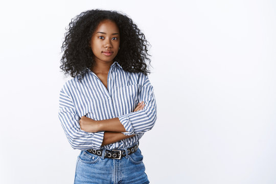 Ambitious good-looking smart creative dark-skinned girl entrepreneur determined achieve goal standing confident arms crossed looking serious self-assured camera, posing white background