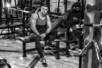 Fototapeta na wymiar health club guy in a gym doing weight lifting