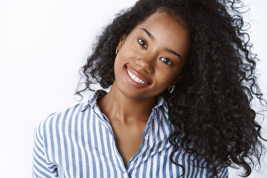 Comestology, Skincare, Lifestyle Concept. Carefree Young Dark-skinned Woman Tilt Head Joyfully Smiling White Teeth Showing Beautiful Strong Curly Hair Delighted Perfect Skin Applying Spa Products