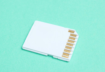 Mini SD memory card on blue background close up