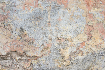 Textured grunge background. Old plastered wall with a multilayer cracked coating. Grunge texture with a deep pattern on whitewashed wall