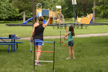 Mom plays ladder toss with daughter
