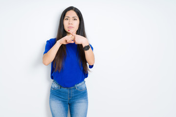 Beautiful brunette woman over isolated background Rejection expression crossing fingers doing negative sign