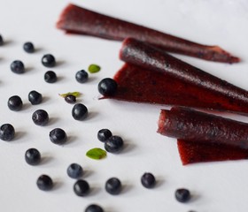 Blueberries are cut into pieces on a gray background