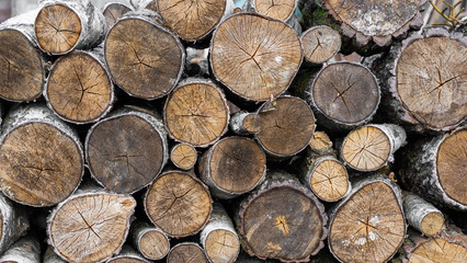 Fototapeta premium logs. firewood. woodpile close up. wood for fireplace. stack of wood for winter. firewood surface background.
