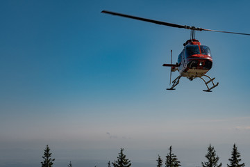 Fototapeta na wymiar A helicopter making a risky landing on a small platform