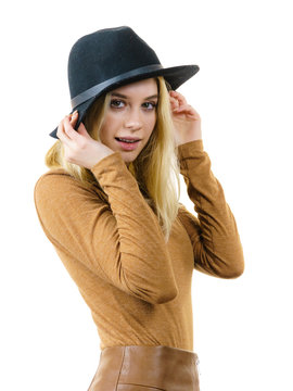 Woman wearing suede and black hat