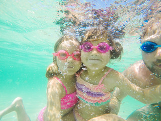 Fototapeta na wymiar Happy children underwater portrait swimming and dive in the sea