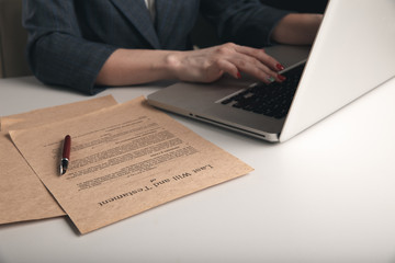 Woman lawyer working on a computer sitting at the table in office isolated