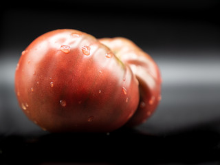 homegrown red tomato isolated on black background