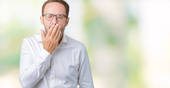 Handsome middle age elegant senior business man wearing glasses over isolated background bored yawning tired covering mouth with hand. Restless and sleepiness.