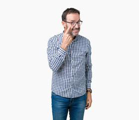 Handsome middle age elegant senior man wearing glasses over isolated background Pointing to the eye watching you gesture, suspicious expression