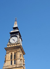 Fototapeta na wymiar the ornate clock tower of the historic 19th century atkinson building in southport merseyside against a blue summer sky