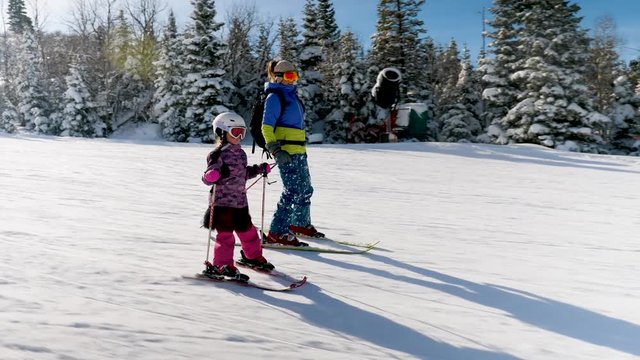 HEBER, UNITED STATES - 01/31/2019: Middle Aged Woman And Her Daughter Are Having Fun Skiing Panning Shot. Beautiful close up tracking shot as mom and daughter are skiing down the slope.