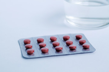 red pills in a blister isolated on white background