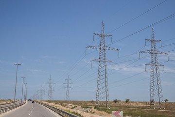 Electricity pylon on nature background . Electricity transmission power lines High voltage tower . Power line high voltage post with blue sky background.