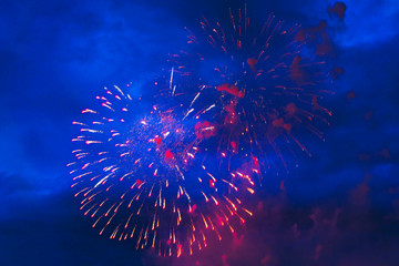 Inexpensive fireworks over the city red, yellow and white. Bright and shiny.  For any purpose. Celebration concept.
