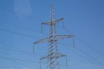 Electricity pylon on nature background . Electricity transmission power lines High voltage tower . Power line high voltage post with blue sky background.