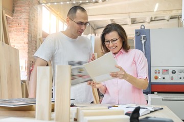 Couple man and woman choosing wooden products, working discussion