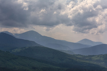 Fototapeta premium Dramatic sky above the Montenegrin ridge, the mountains of Goverla and Petros. Carpathians