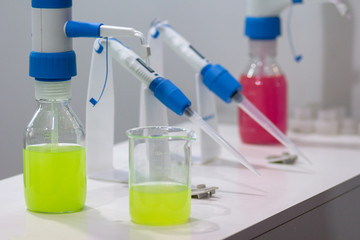 Flasks with a multi-colored solution on the table in a medical laboratory. Medicine