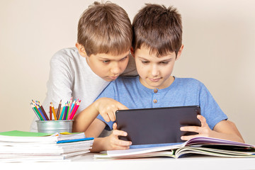Fototapeta na wymiar Kids using together tablet computer at home