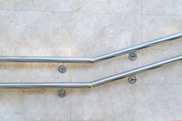 Metal handrail on the wall near the stairs