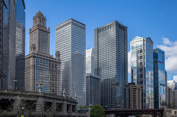 Fototapeta na wymiar Chicago city skyscrapers on the river canal, blue sky background