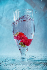 fresh strawberries in water with splashes and bubbles