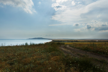 Dirt road by the sea among the fields. Black Sea. Depth of Russia.