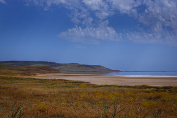 The wealth of Russia. Wild places. Pink Salt Lake. Behind the lake there are hills of small...
