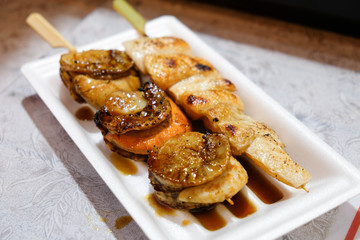 Seafood salmon and scallop meat skewer sold in Osaka food street in Japan.