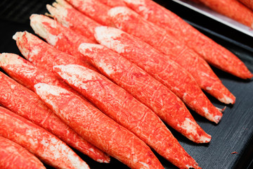 Surimi white fish stick displayed at Japan street food market. Also known as imitation crab meat sticks.