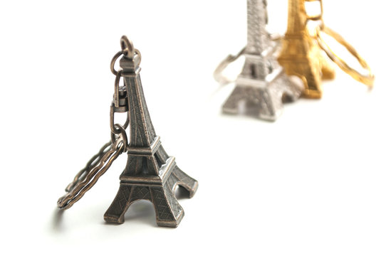 Closeup of metallic Eiffel tower miniature on white background