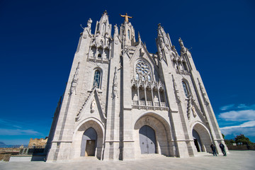 Fototapeta na wymiar Barcelona, Spain - April, 2019: Tibidabo Cathedral. Temple of the Sacred Heart of Jesus at Mount Tibidabo. Barcelona, Spain. Blue sky with cloud of spring day. Famous landmark in Catalonia.