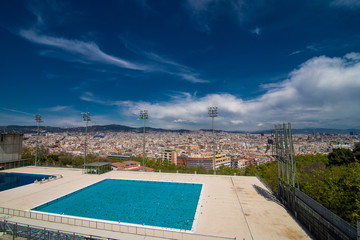BARCELONA, SPAIN - April, 2019. Olympic swimming pool with a view on Barcelona city. Montjuic mountain.