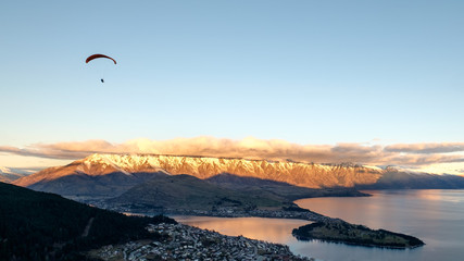 Aerial view of Queenstown, New Zealand. Suitable for travel image. Famous tourist destination, activity and attraction. Leisure image of paragliding and adventure.