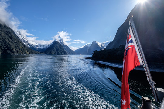 In Milford Sound Cruise, One Experience The Spray Of A Waterfall Close To Sheer Rock Faces. A Popular Tourist Destination And Natural Landscape In New Zealand. This View Is Breathtaking And Iconic.