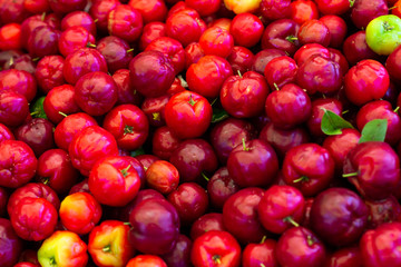 Numerous cherries in the market. Fresh fruits of the tropic. Some Colorful sweet and sour fruits.