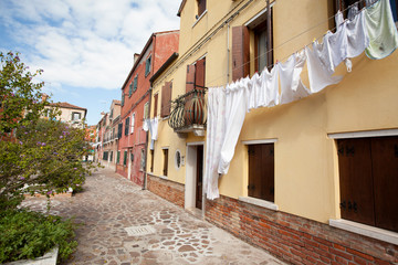 Fototapeta na wymiar street in old town Burano island italy with laundry 