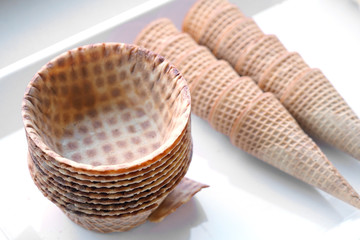 close up on cone and bowl of ice cream